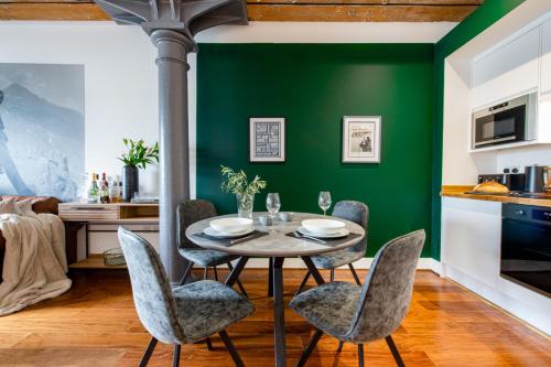 a dining room with green walls and a table and chairs at RWY Suite007 Luxury Signature Apartment with sea view in Plymouth