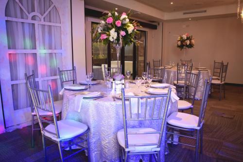 a dining room with a table with chairs and flowers at Hotel 101 Park House in Bogotá