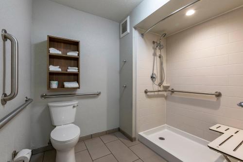 a bathroom with a toilet and a bath tub at MainStay Suites Coeur d'Alene in Coeur d'Alene
