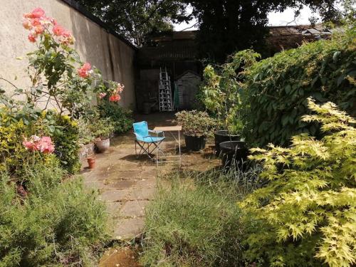 a patio with a table and chairs in a garden at 3 Bed Ground Floor Flat in London