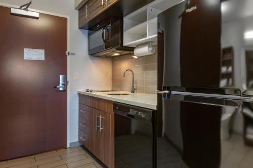 a small kitchen with a sink and a stove at MainStay Suites Coeur d'Alene in Coeur d'Alene