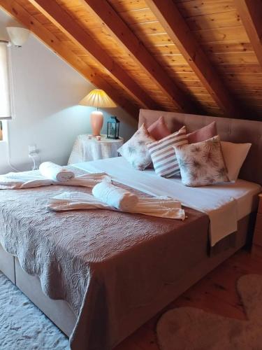a bedroom with a large bed with pillows on it at Luxury Villas Chrysa Private Pool & Spa in Nafplio