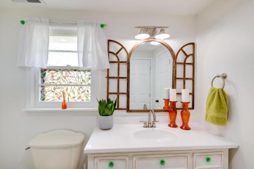 a bathroom with a sink and a toilet and a mirror at Charming Country Cottage in Goodspring! in Pulaski