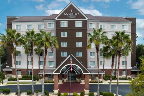 a rendering of the front of a hotel with palm trees at Country Inn & Suites by Radisson, Gainesville, FL in Gainesville