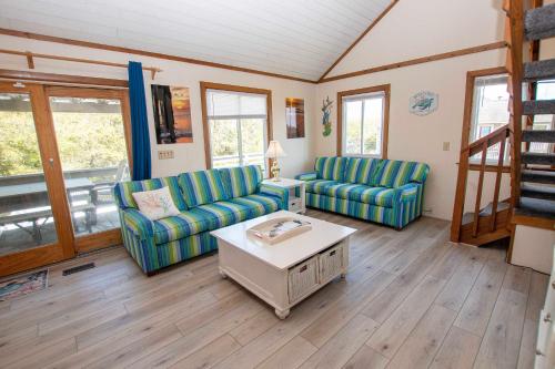 a living room with two chairs and a coffee table at Oceanside, Private Pool, Hot Tub, MIL Suite, KH529, Sea Turtle Sunrise in Kitty Hawk