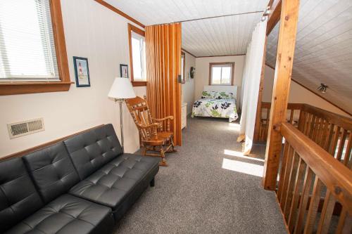 a living room with a couch and a bedroom at Oceanside, Private Pool, Hot Tub, MIL Suite, KH529, Sea Turtle Sunrise in Kitty Hawk