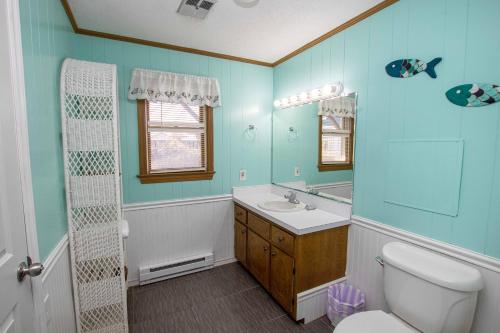 a bathroom with a toilet and a sink and a shower at Semi-Oceanfront, Ocean Views, Private Pool, Hot Tub, KH4216, Freedom in Kitty Hawk