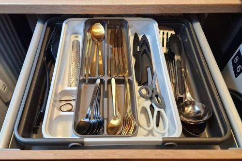 a drawer filled with utensils and spoons at Dark Jungle Suite: Seltersweg Netflix TV & Jumanji in Gießen