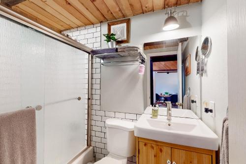 a bathroom with a sink and a toilet and a shower at Hilltop Lodge in Stateline
