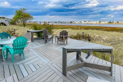 a wooden deck with tables and chairs and a lake at Audrey Leigh in Newburyport