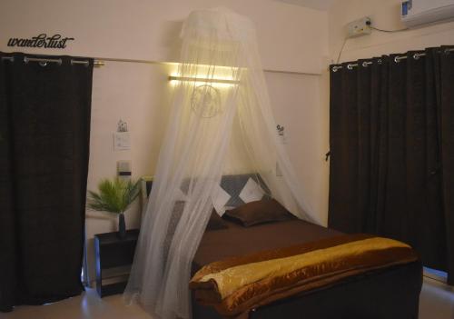 a bedroom with a bed with a mosquito net at Mountainview Paradise in Karjat