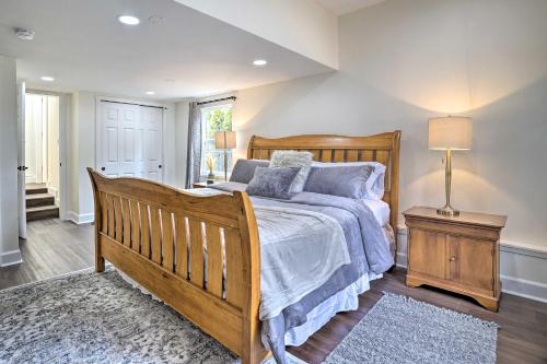 a bedroom with a large wooden bed and a lamp at Lovely Redmond Home about 17 Mi to Downtown Seattle! in Redmond