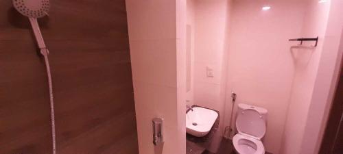 a bathroom with two toilets and a shower at SleepRest @ NTC in Nagoya