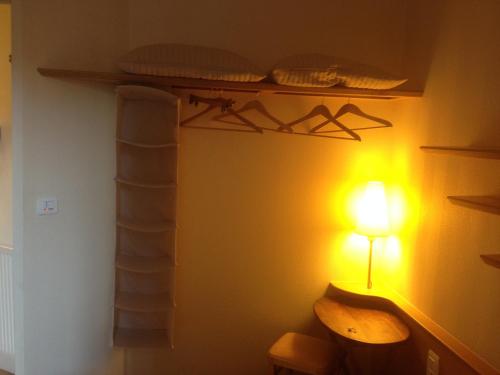 a room with a shelf and a light on a wall at Hôtel San Pedro in Saint Malo