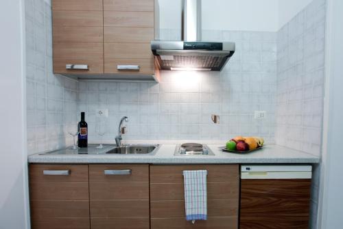 a kitchen with a sink and a bowl of fruit at Hotel Residence Nemo in Brindisi