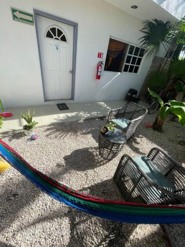 a hammock in front of a house at Brisa del mar Holbox in Holbox Island