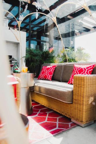 a couch in a room with red pillows on it at Virgin Hotels New Orleans in New Orleans
