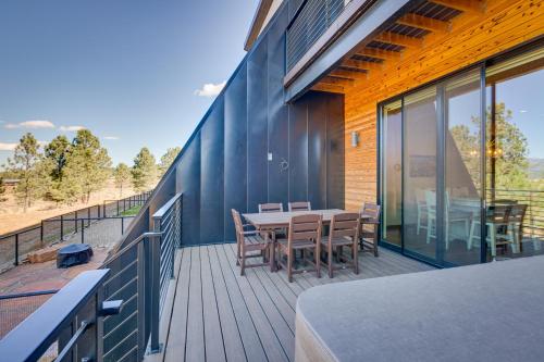 a deck with a table and chairs on a house at Angel Fire Home with Hot Tub Less Than 1 Mi to Ski Slopes! in Angel Fire