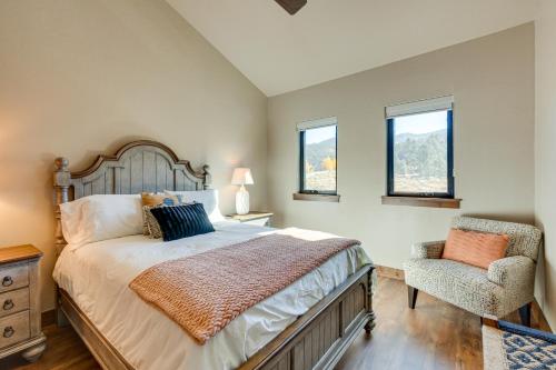 a bedroom with a large bed and a chair at Angel Fire Home with Hot Tub Less Than 1 Mi to Ski Slopes! in Angel Fire