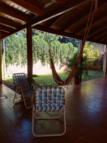 two chairs and a hammock on a porch at Tres soles in Posadas