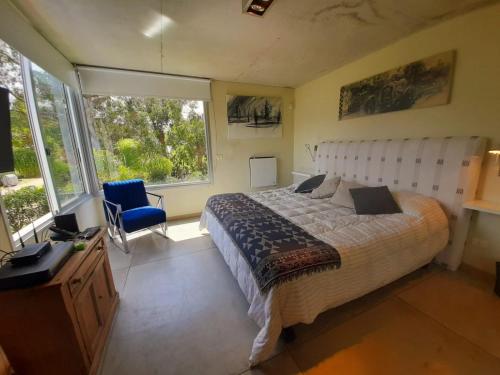 a bedroom with a large bed and a large window at AQUI NO ES in Punta del Este