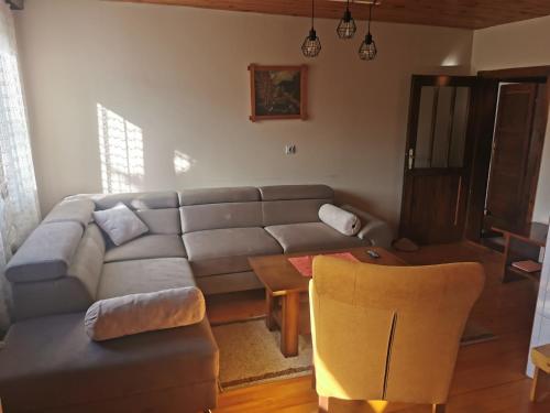 a living room with a couch and a table at Planinski Mir in Zaovine