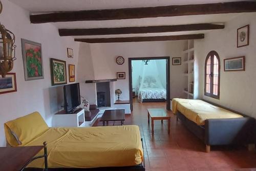 sala de estar con sofá y habitación con cama en Finca David Galdar, en Las Palmas de Gran Canaria