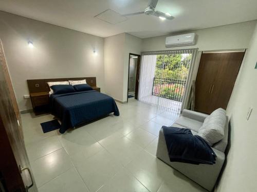 1 dormitorio con 1 cama y 1 sofá en Amplio departamento a estrenar en Asunción, excelente ubicación, en Asunción