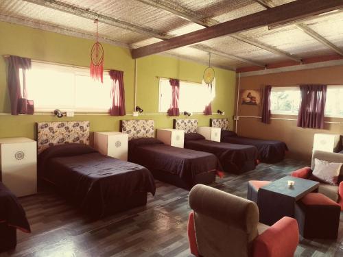 a living room with couches and chairs and windows at Sentir Indiano in Valeria del Mar