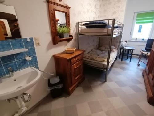 a bathroom with a sink and a bunk bed at Zur goldenen Glocke Inhaberin Katja Koppik in Dassel