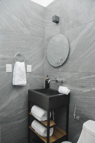 a bathroom with a black sink and a mirror at CASA LUMBA in Guadalajara
