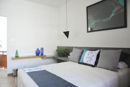 a bedroom with a large white bed with pillows at CASA LUMBA in Guadalajara
