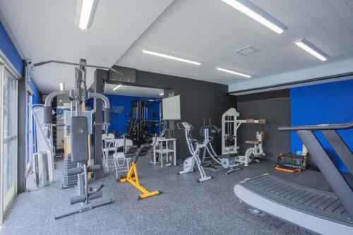 a gym with treadmills and machines in a room at OSAKA NOSE Farmer's Guest House　YASUDA FARM in Nose
