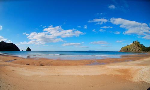 a beach with rocks in the water and a blue sky at CASA DE ALOJAMIENTO PRIVADA 