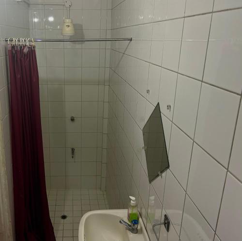 a bathroom with a sink and an umbrella on the wall at Tamernique Apartments in DʼArbeau