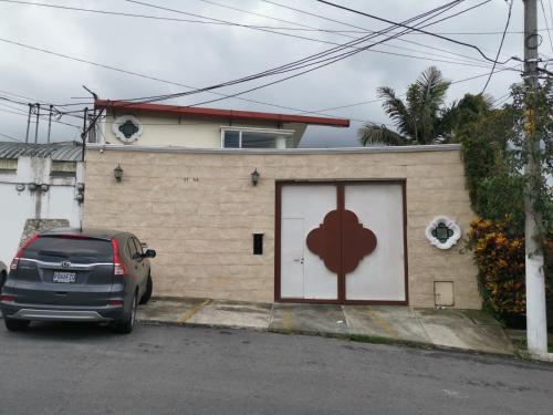 a car parked in front of a building with a door at Cozy Apartment I in Guatemala