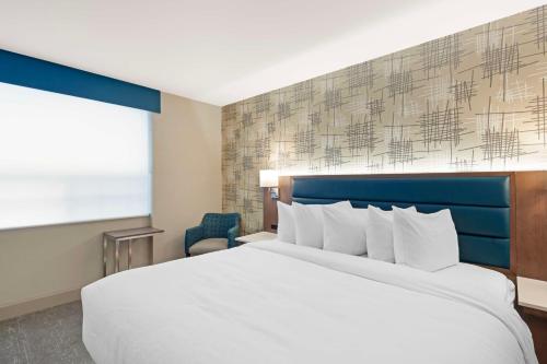 a hotel room with a large bed and a window at Best Western PLUS City Centre Inn in Edmonton