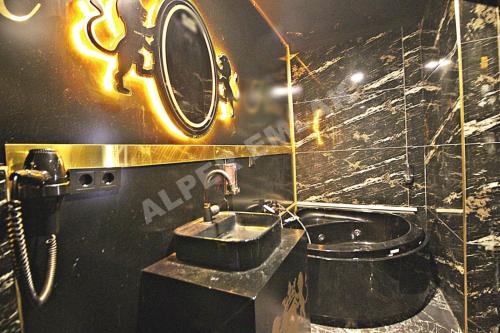 a bathroom with a sink and a mirror at Black House Otel in Ankara