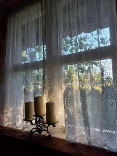 a window with two candles on a window sill at Magaze de Luxe in Gradačac