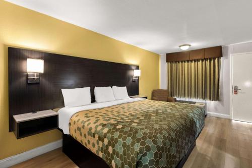 a hotel room with a large bed and a window at Econo Lodge White Pine Morristown I-81 & I-40 Split in White Pine