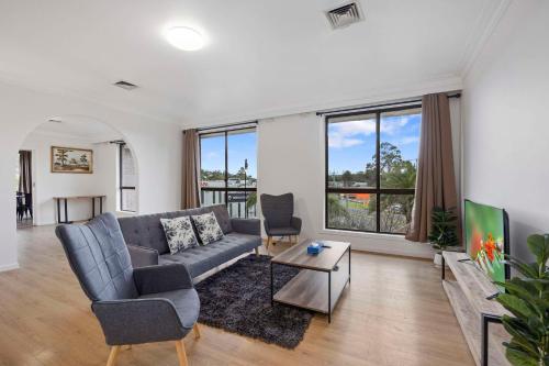 a living room with a couch and a table at Econo Lodge Lilydale in Lilydale