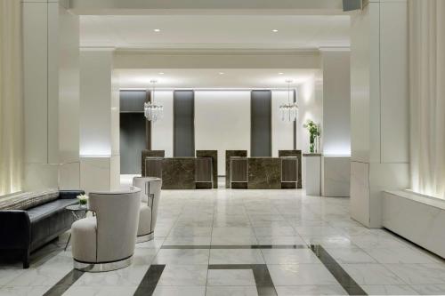 a living room with a couch and a lobby at Hilton Boston Park Plaza in Boston