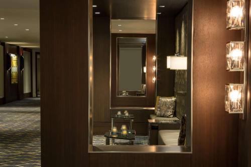 a lobby with a mirror and a table with candles at Hilton Boston Park Plaza in Boston
