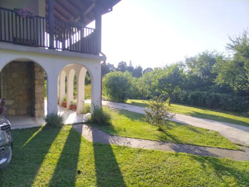 a porch of a house with a grass yard at Dunavski konaci in Brestovik