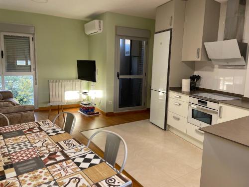 een keuken en een woonkamer met een tafel en een keuken bij Apartamento Rural El Estrecho de Arguedas in Arguedas