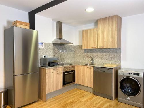 a kitchen with a stainless steel refrigerator and a dishwasher at Vistas Al Valle De Arinsal 434 - Caminando a Pistas 1 MINUTO - 1Parking in Arinsal