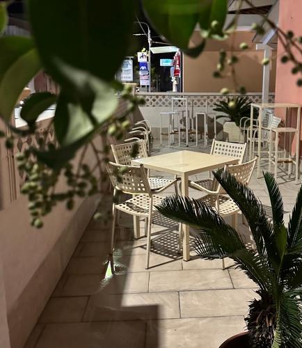 a table and chairs and a table and chairs at A Due Passi dal Mare in Catanzaro