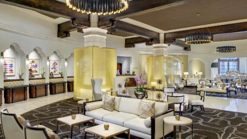 a lobby of a hotel with couches and tables at Green Valley Ranch Resort Spa Casino in Las Vegas