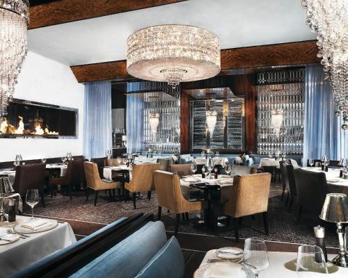 a restaurant with tables and chairs and a chandelier at Green Valley Ranch Resort Spa Casino in Las Vegas