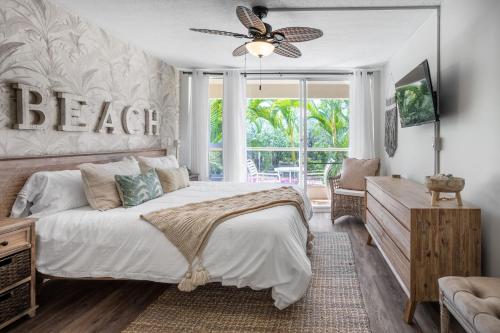 a bedroom with a bed and a ceiling fan at Walk to Beach from this Renovated Studio with King Bed and Resort-Level Amenities in Wailea